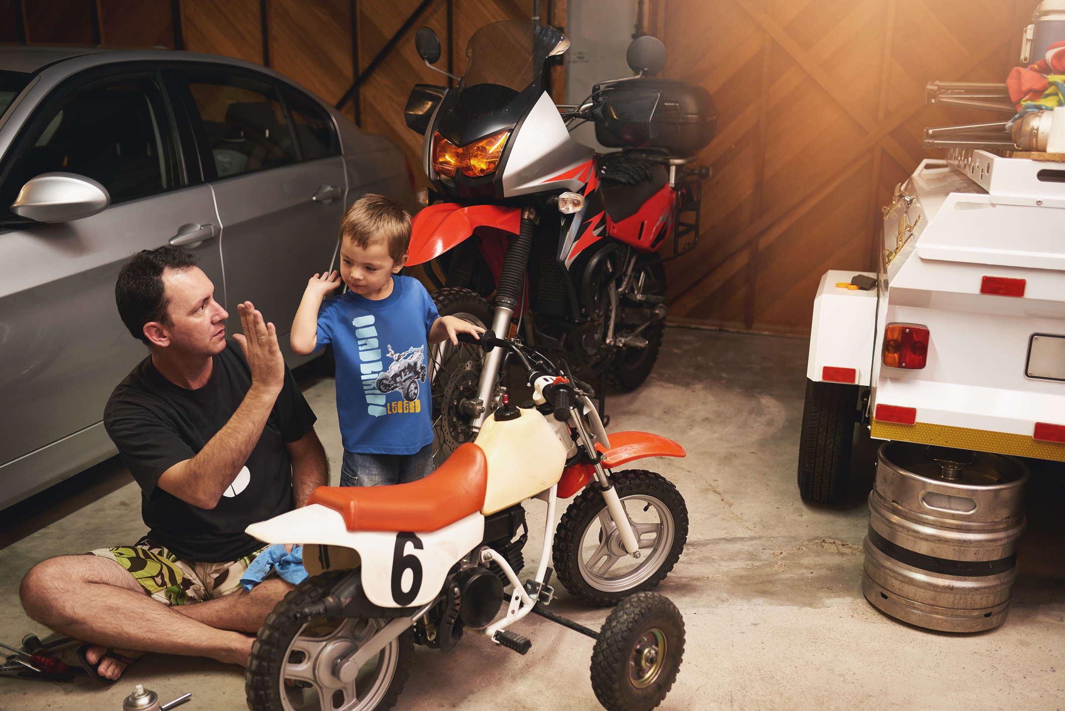 Father and son working on motorcycle