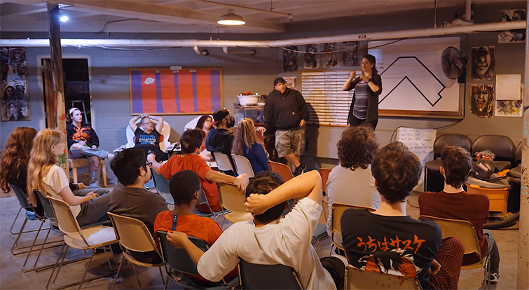 Cast members recieve instructions before a rehearsal.